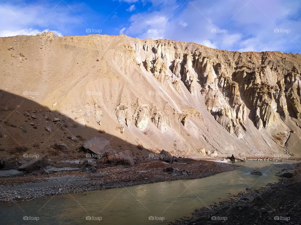 mountain river in the Himalayas with clouds sky