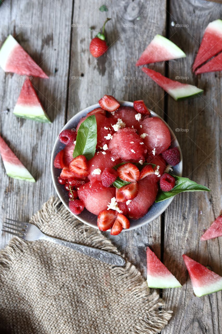 watermelon and berries salad on the table flat lat