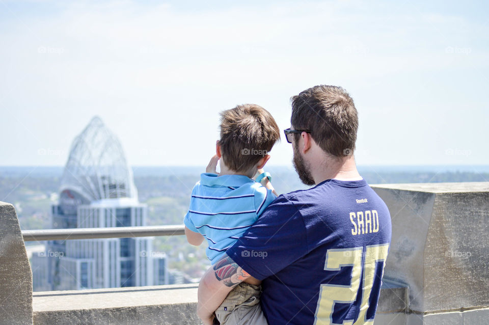 Father and son looking out at Cincinnati skyline