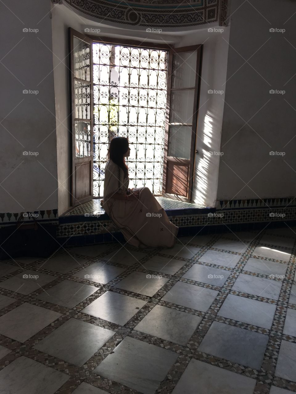 Woman in shadows at palace in Marrakech 