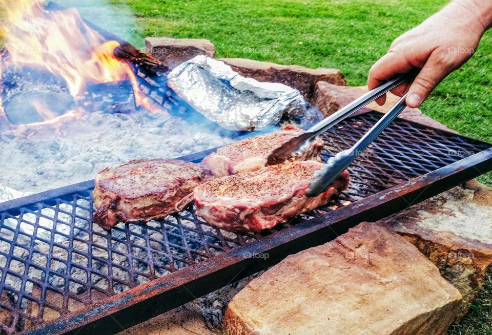 Cooking Steaks on an Open Pit Fire in Texas