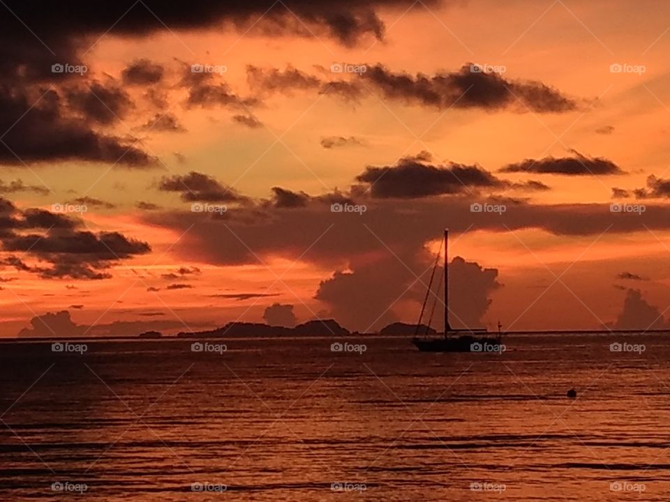 ic sunset, islands, sailboat sillouette in Malaysia. seascape, beach view, dusk, dark orange, stunning