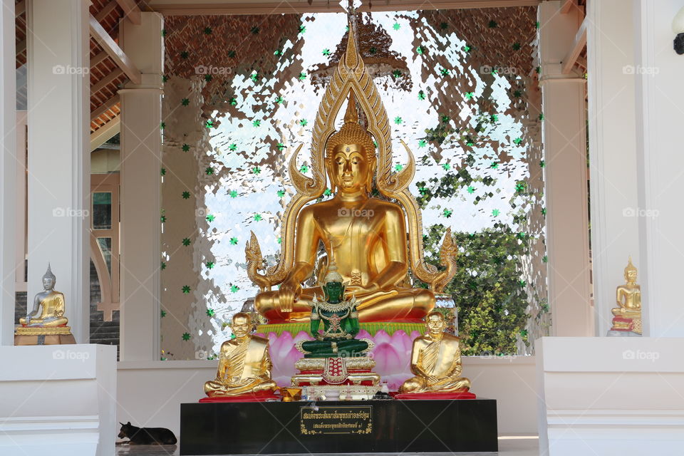 Statues in Krabi Thailand.  Beautifully kept and clean. A local dog was just relaxing next to the statues.