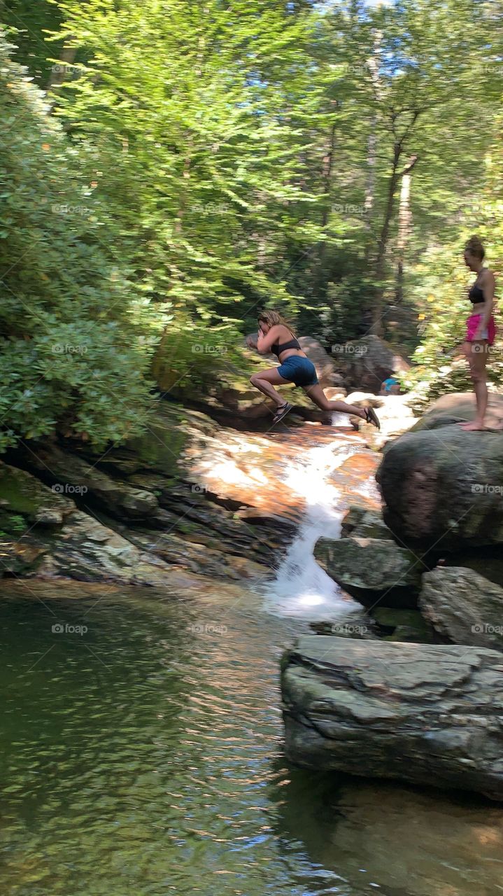 Taking a big leap of faith into Skinny Dip Falls in Western North Carolina. The water is cold, but refreshing. 