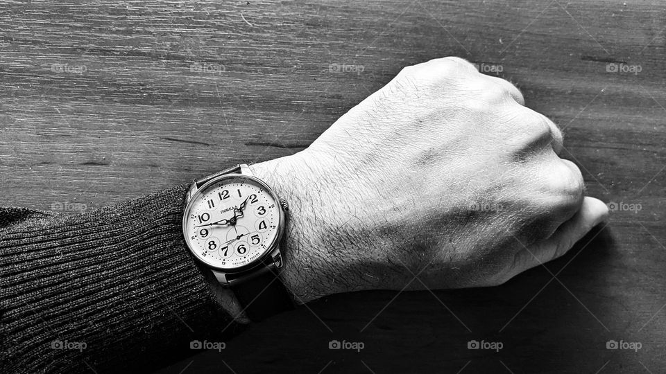 Soviet watch Pobeda on a leather strap on a man's hand