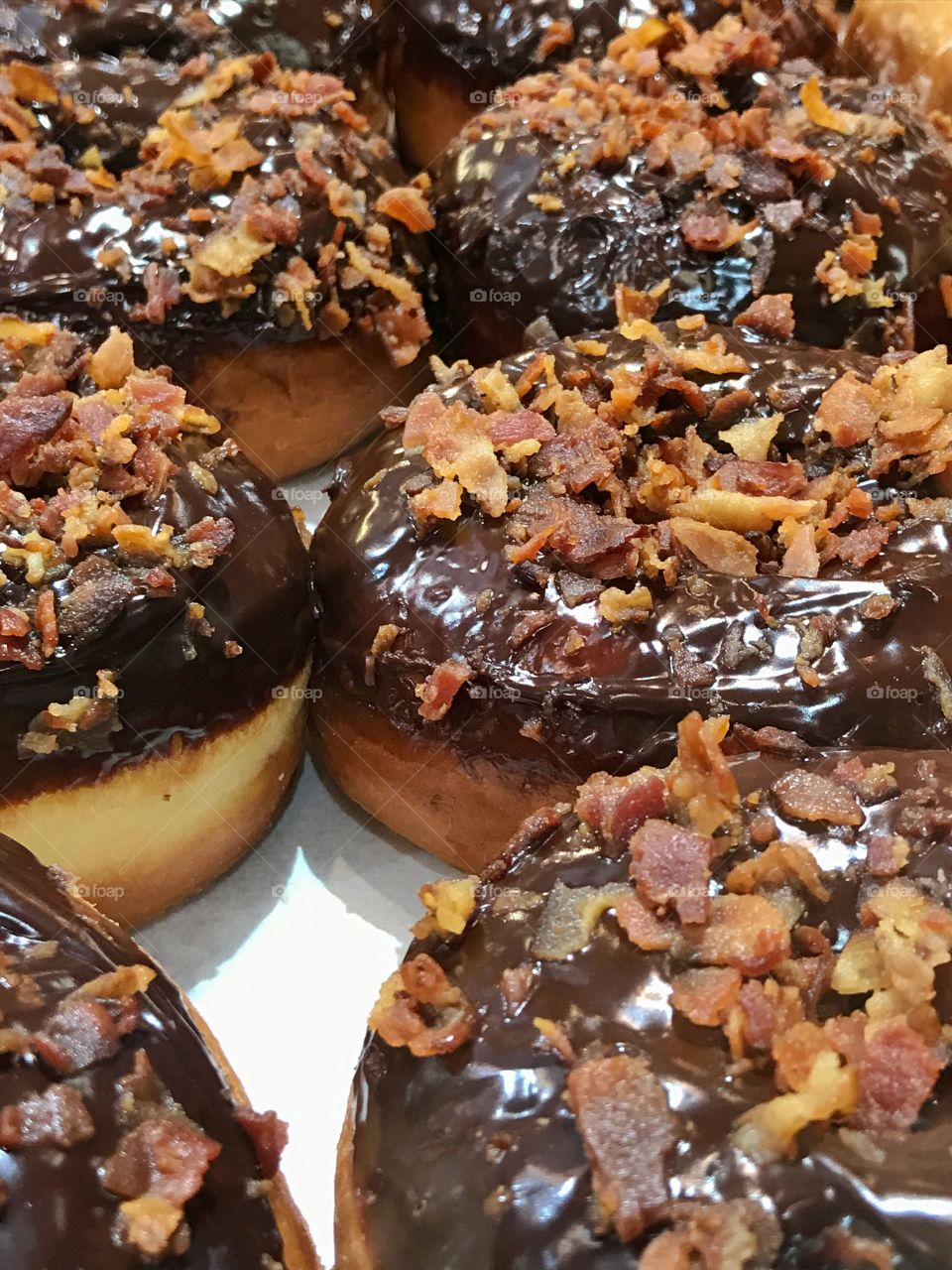 Chocolate covered donuts with bacon bits