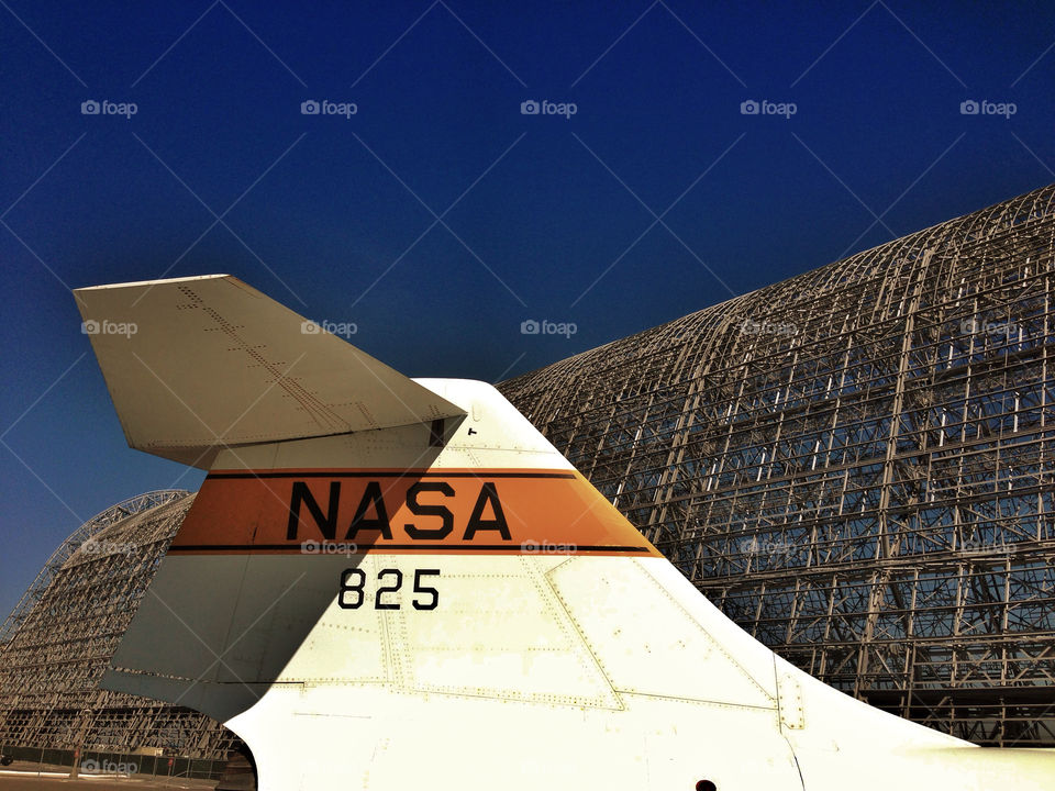 Tail of a NASA research aircraft with NASA logo in front of a giant