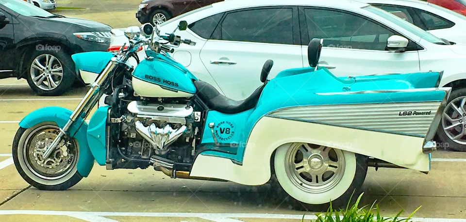 Turquoise colored motor cycle with 1957 Chevy Bel Air rear end and engine 