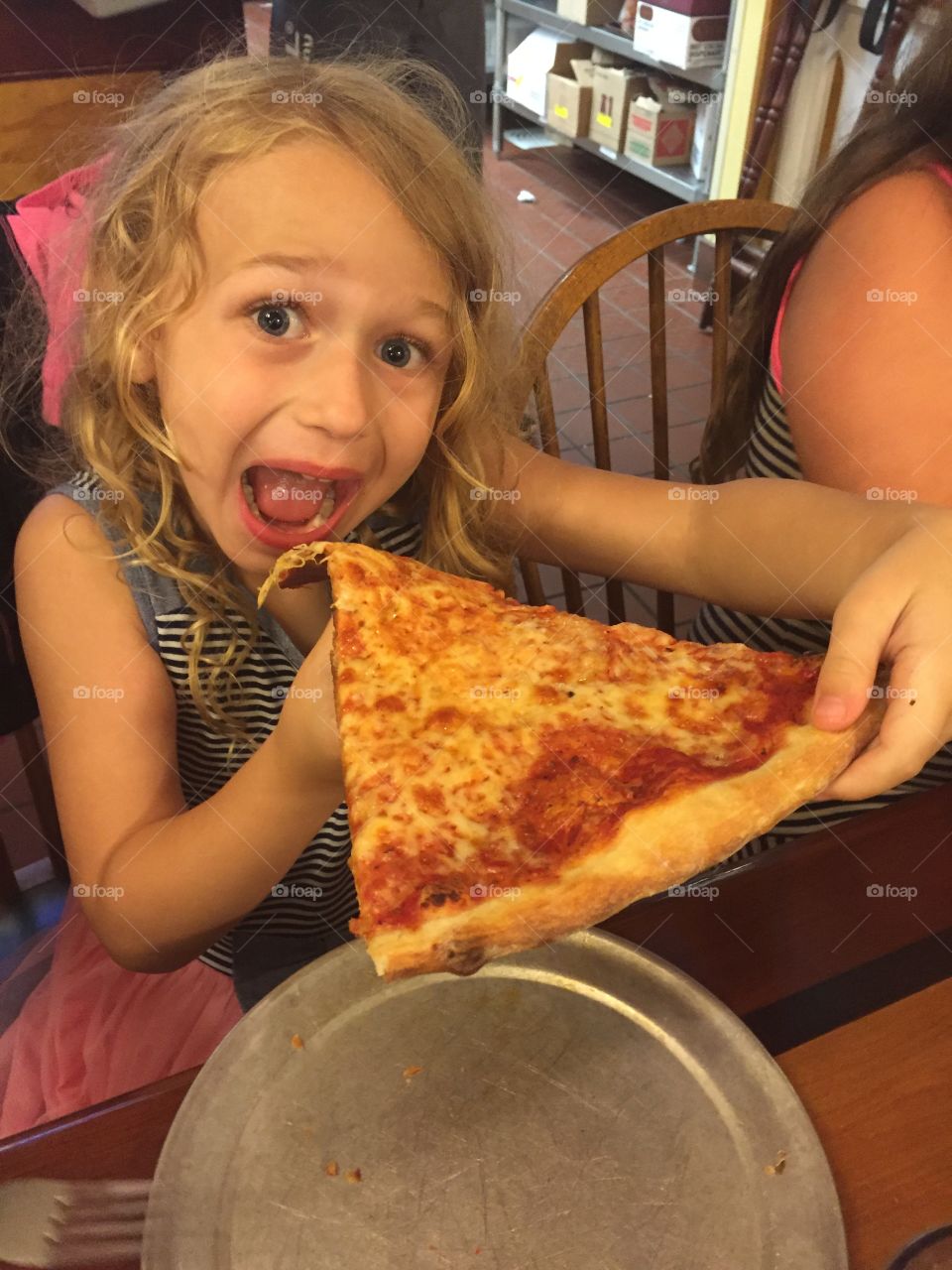 Girl holding pizza slice