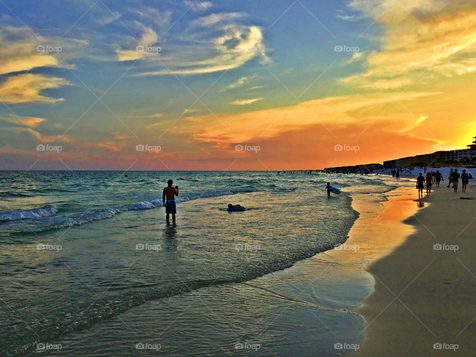 Sunset on the beach in front of the Gulf of Mexico - 
The sunset was a perfect conclusion of the day. It was silky, smooth collusion of sky burst reds, yellows, various hues, orange, tangerine and blue metallic gold