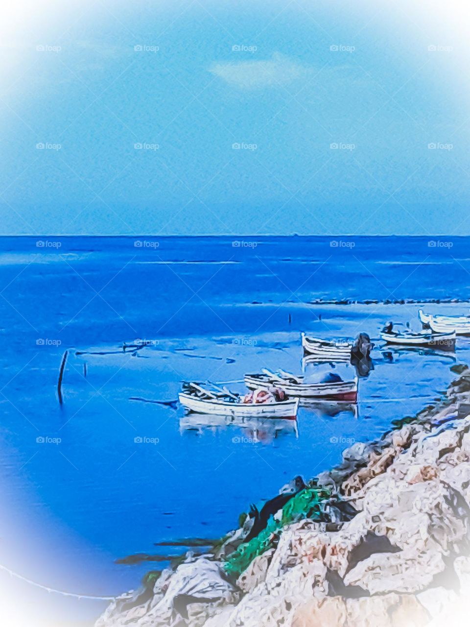 A picture taken from the land side of a fishing port
The boats are lined up quietly on the shore
The blue of the sea is wonderful with the clarity of the sky and the absence of clouds