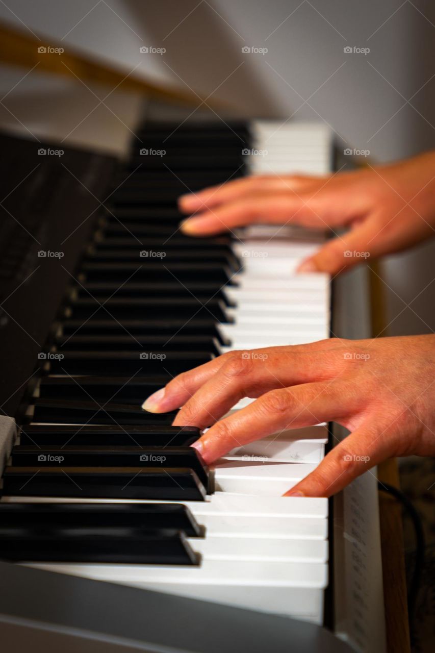 Hands of person playing the piano