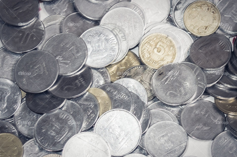 Stock pile of Hundred number 1, 10, 5 Indian rupee metal coin currency on isolated background. Financial, economy, investment concept. Banking and exchange object. closeup. Vintage tone filter effect.