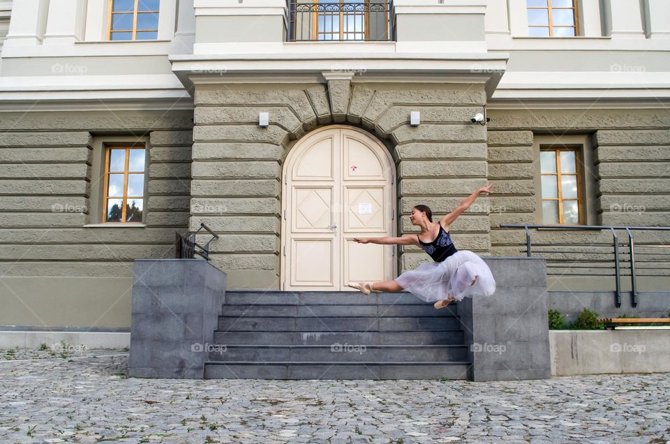 Ballerina jumping on the street