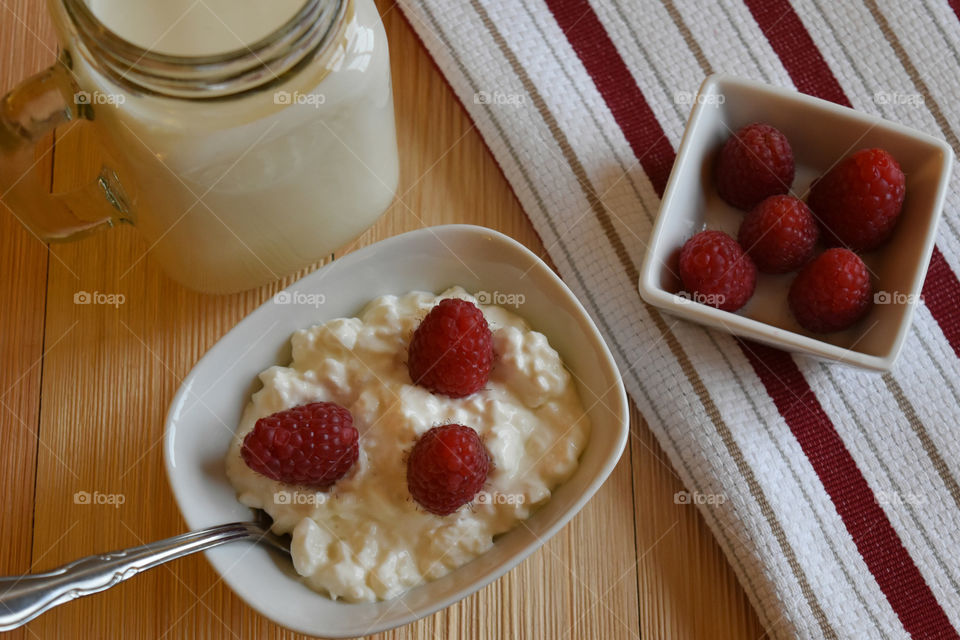 Cold glass of milk with fruit and cottage cheese