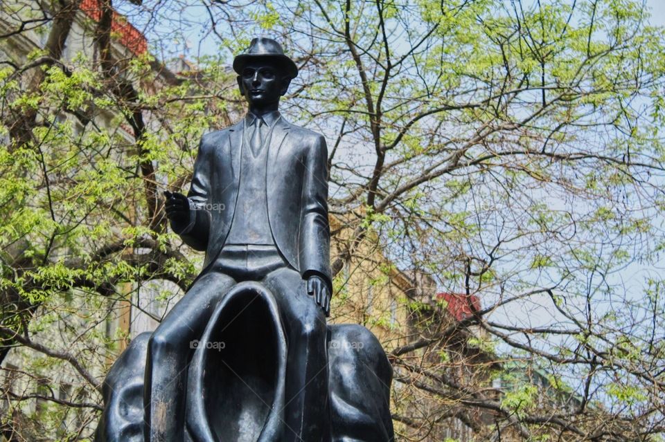 Man statue, trees, Prague.