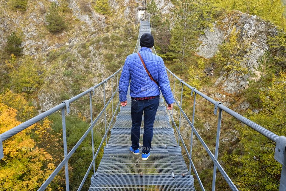 Man with his back to the Tibetan bridge