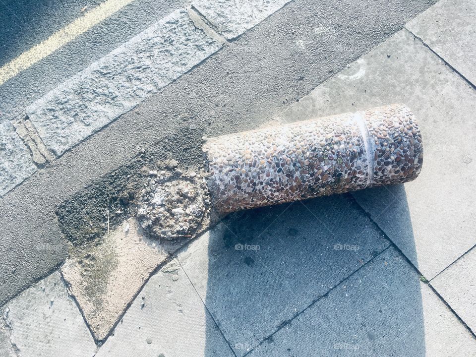 Damaged concrete bollard on Edgwarebury Lane, Edgware, Middlesex 