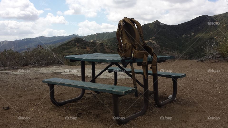 hiking pack on mountain top table