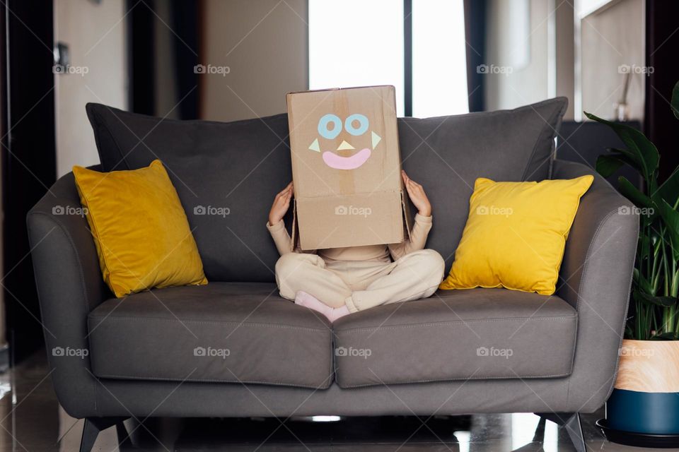 Kid sitting on couch at home 