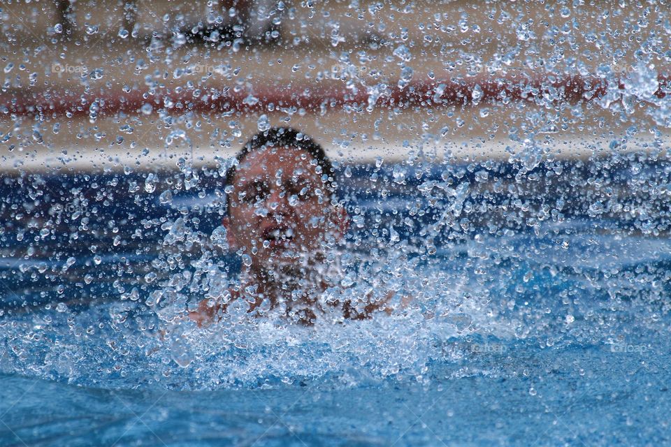 Young man swimming in pool 