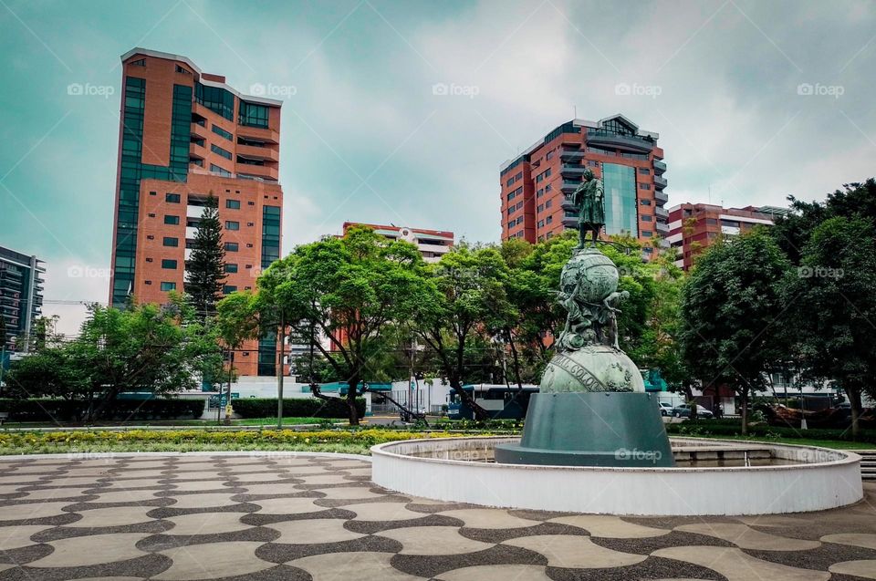 Monument to Christopher Columbus in Guatemala City, with a beautiful view of the buildings and trees that adorn it