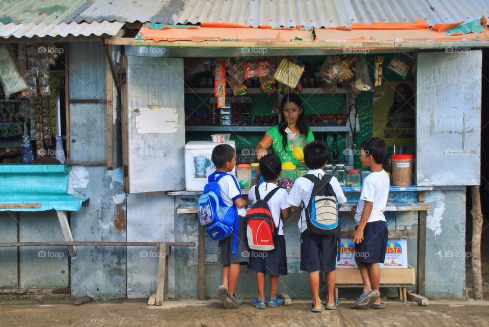 A sari sari store vendor and kids