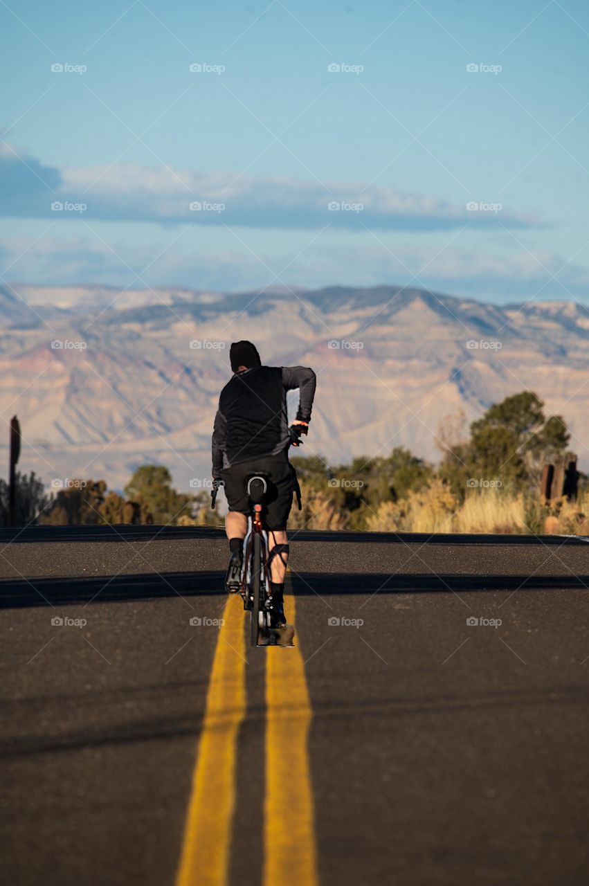 A cyclist on the middle of the road 
