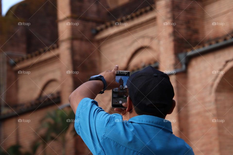 Man is taking a picture on his phone