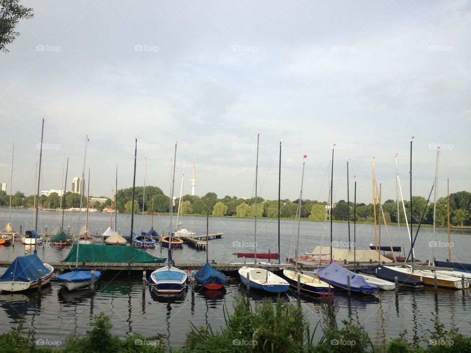 Marina. Boats anchored viewed from park path around Alster Lake in Hamburg, Germany.