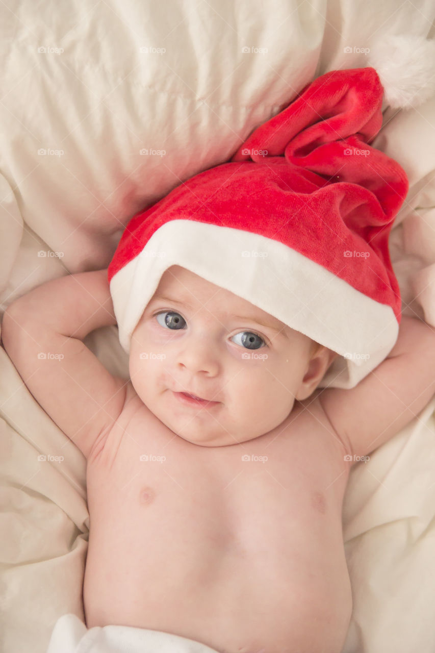 High angle view of baby wearing santa hat