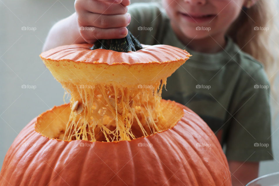 A child getting ready to carve a pumpkin