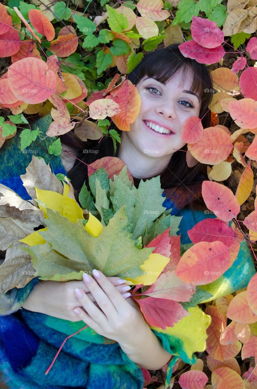 Smiling Young Girl on Autumn Background