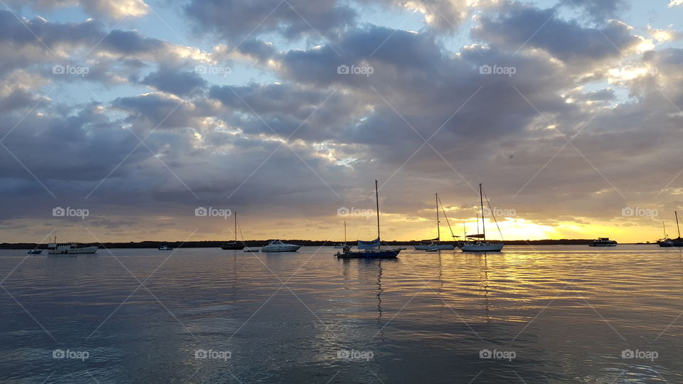 watching the sun rise with the sail boats