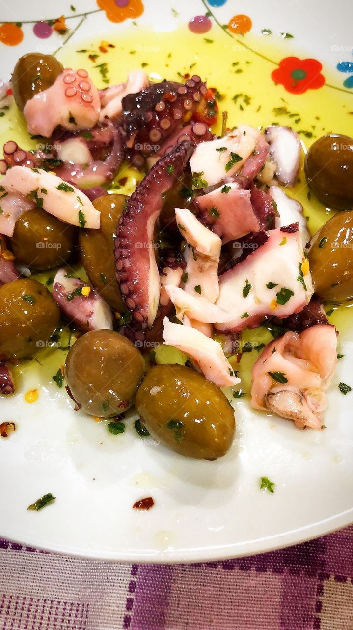 Salad: olives, chopped octopus, red beans and cucumbers