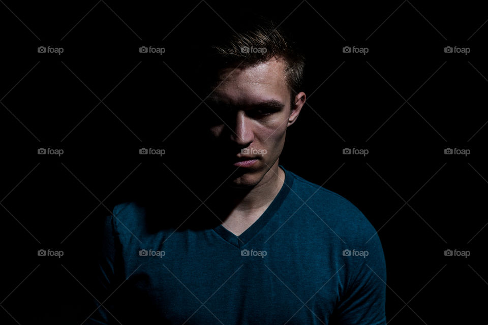 Man standing against black background