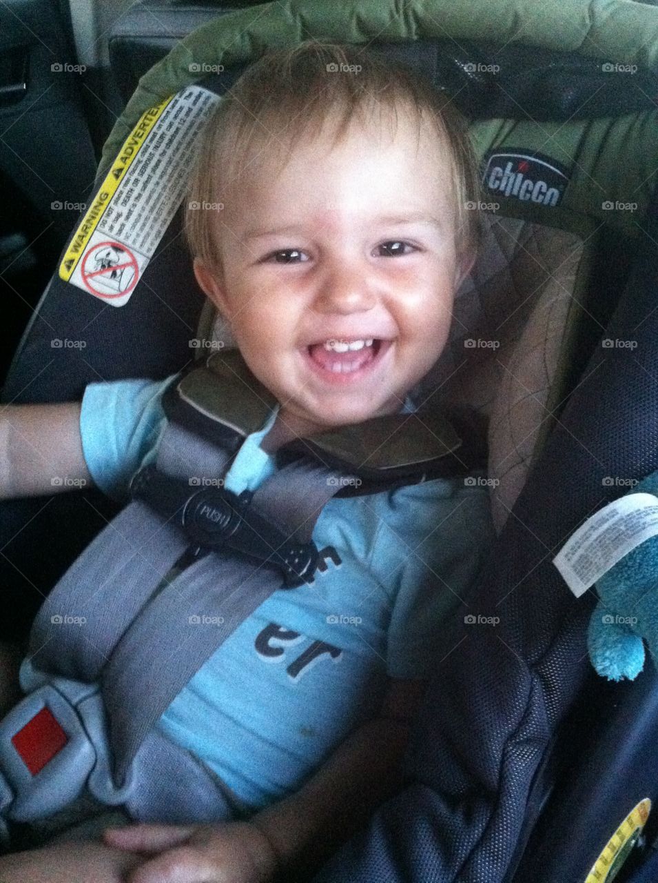 Happy tot. 16 month old smiling in his car seat 