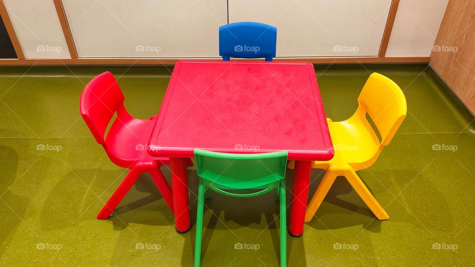 A children table and chair for crafting or group activity.