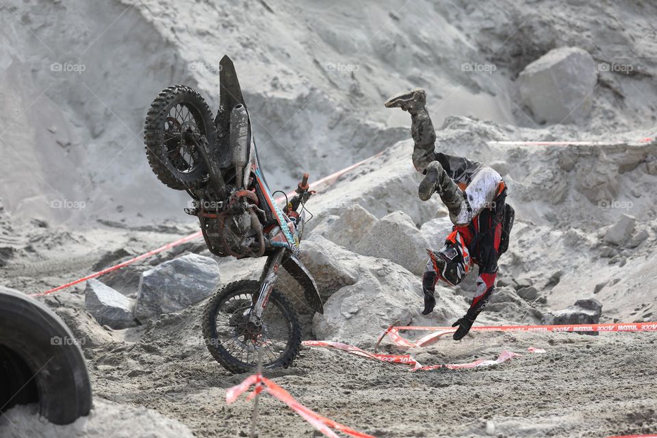 Falling biker with bike during the race