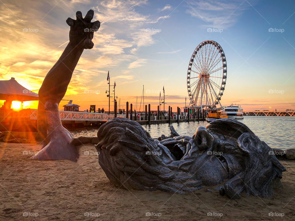 Peaceful anguish at National Harbor in Maryland. The Awakening, as its formally called, is a startling contrast to the peaceful background.