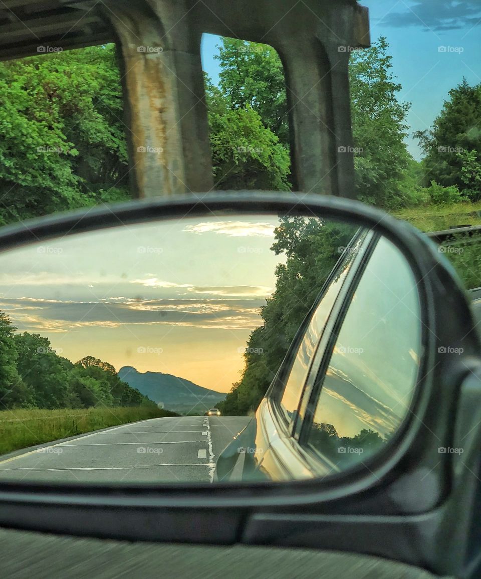 Traveling in the evening has its perks. A glorious sunset in the distance waves goodbye as it slips to another part of the world.