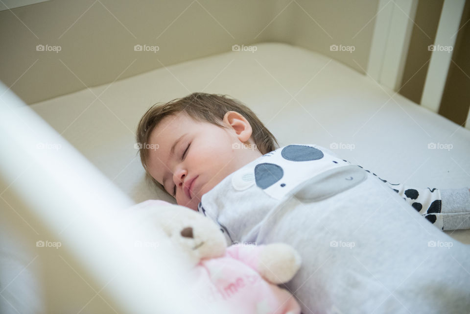 Elevated view of a baby boy sleeping in cradle