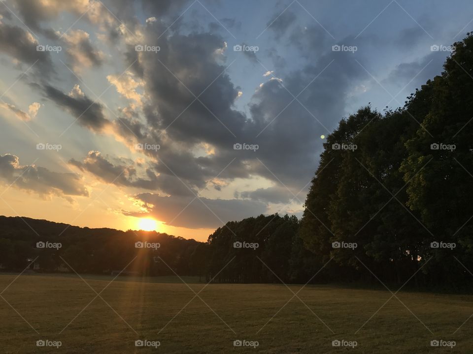 Sunset on a clear sunny day with rays of sun showing