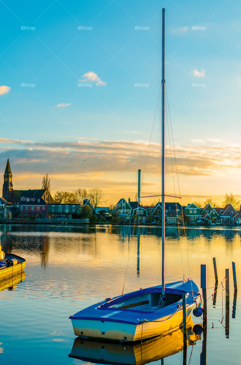 A boat moored in a river at sunset at Zaanse Schans, Holland