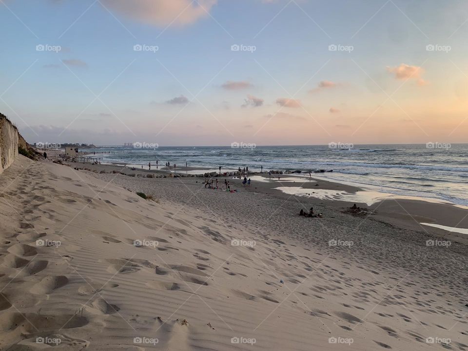 Beach with a sand dune at sunset
