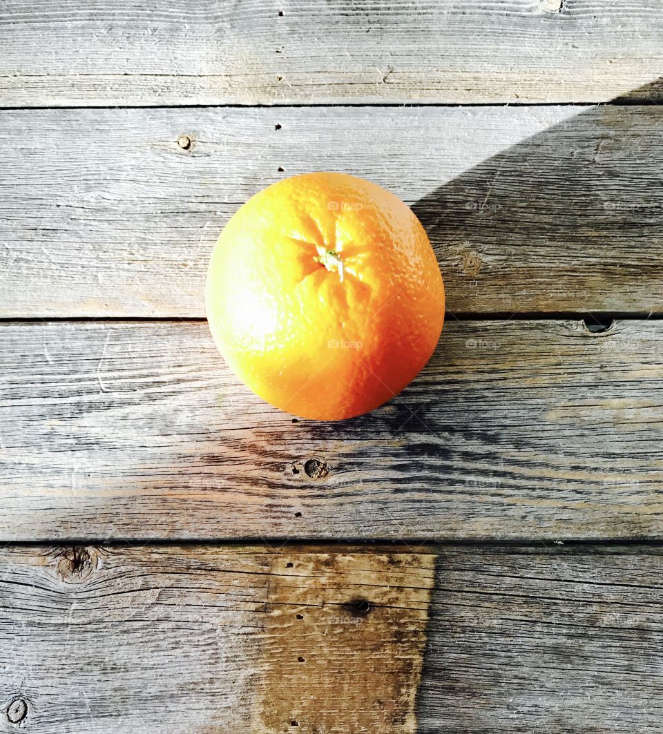 Orange on Wood Table