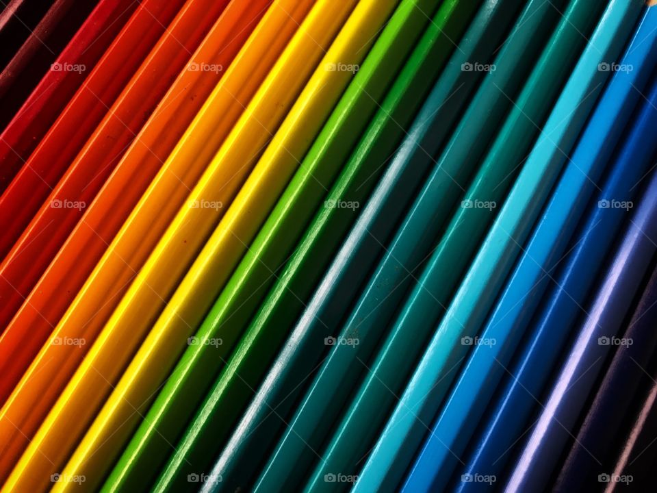 A rainbow of colored pencils. A beautiful and bright effect of colors, from red to violet.
