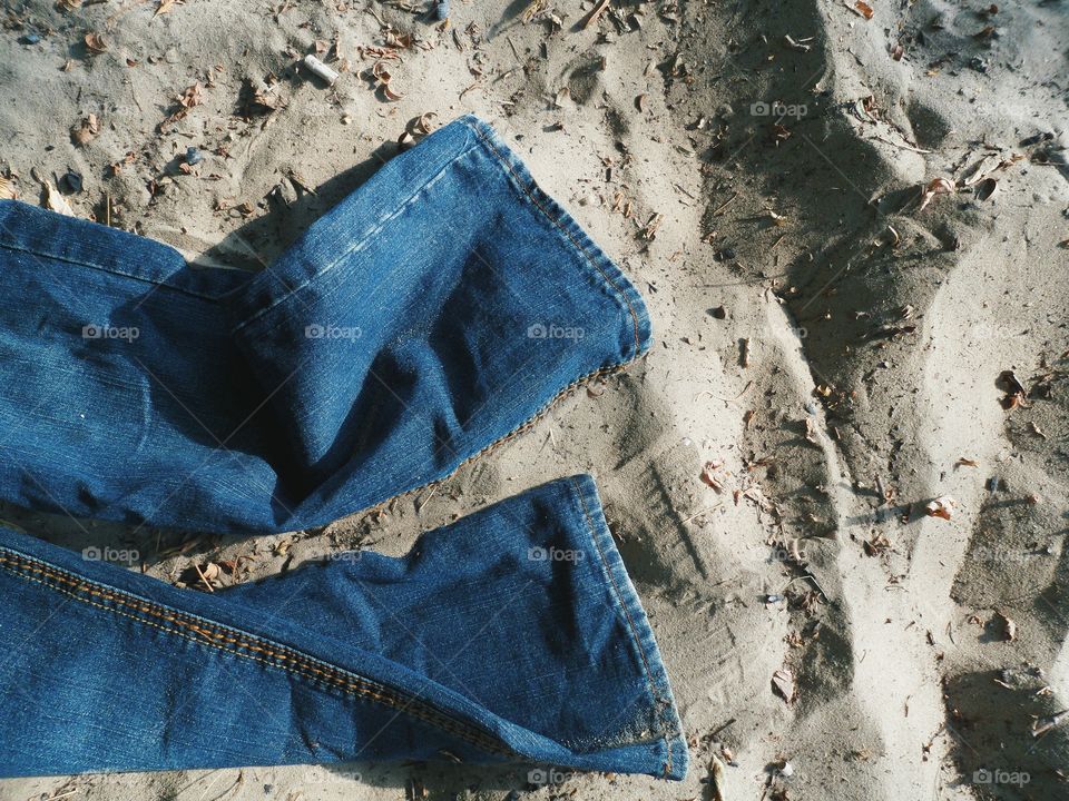 Jeans lie on the sand