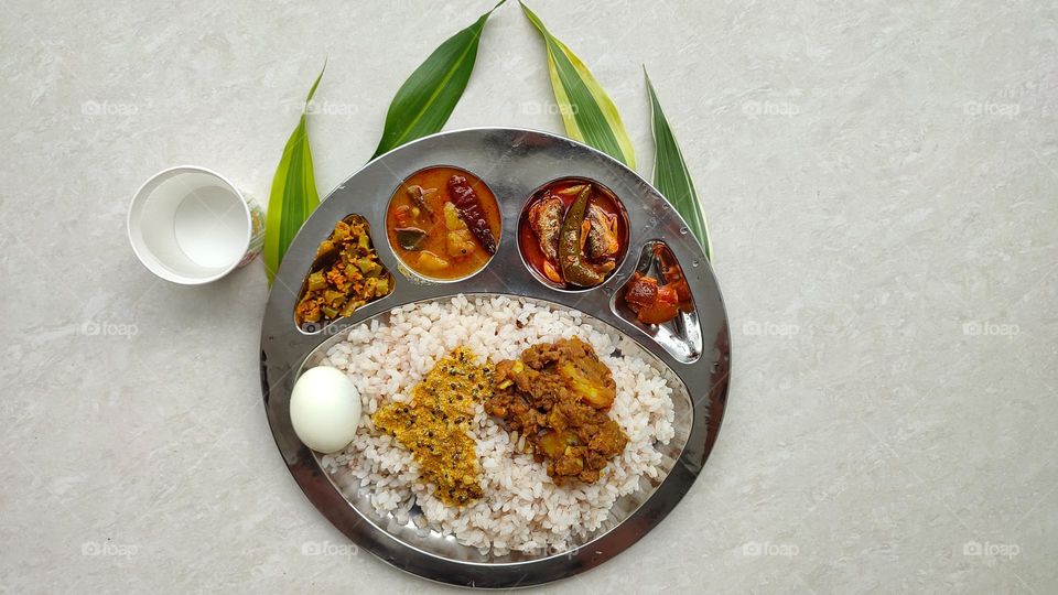 Healthy and tasty Indian Meal, Beautiful presentation of Indian food, spicy foods, vegetarian and non-vegetarian food, Rice Thali, Egg, best food, tasty foods, fish curry, sambar, lemon pickle