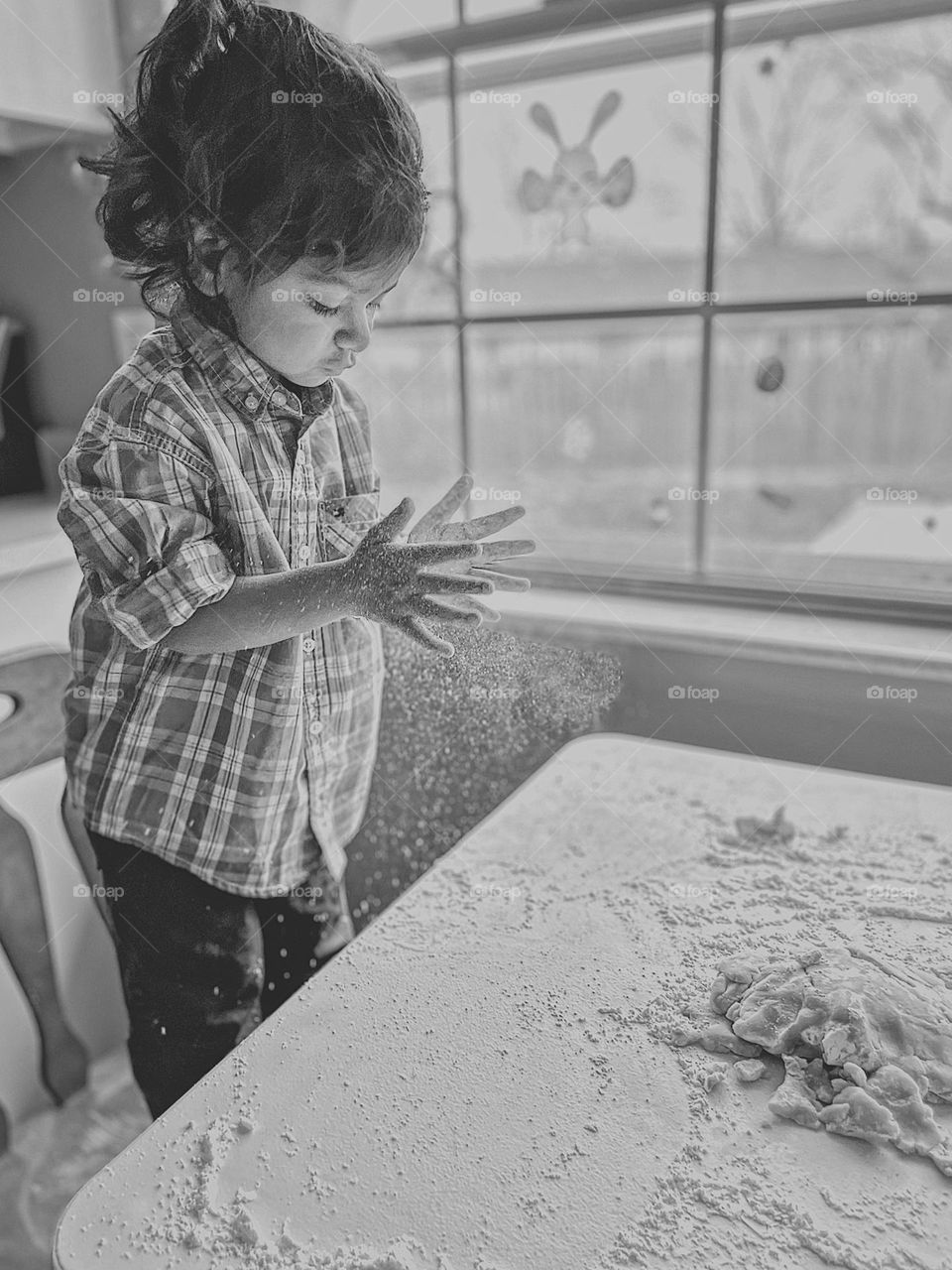 Toddler girl baking cookies, toddler makes Easter sugar cookies with Mommy, making cookies with mommy, baking at home, Easter traditions at home, making cookies with toddlers, baking with kids, little girl claps hands with a cloud of flour